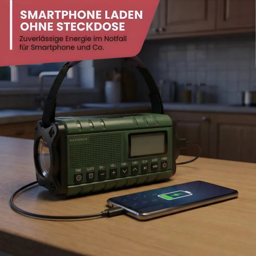 Grünes Kurbelradio auf der Küchenarbeitsplatte lädt per Kabel ein Smartphone
